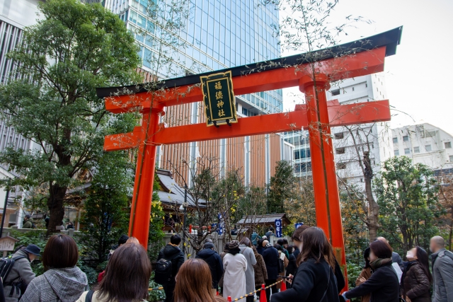 大きな赤い鳥居をくぐる人びと